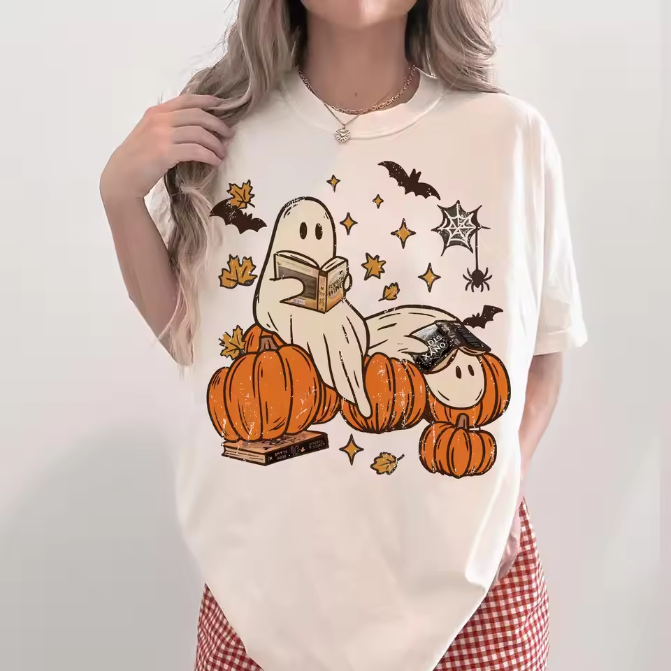 Two ghosts reading on pumpkins with fall leaves and bats
