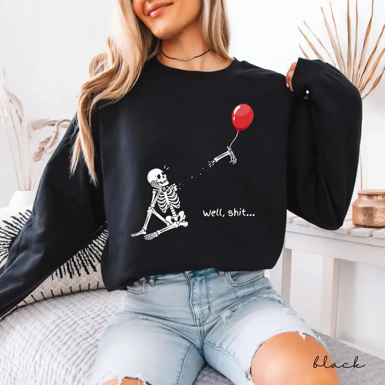 Skeleton Sitting with Lost Arm and Balloon